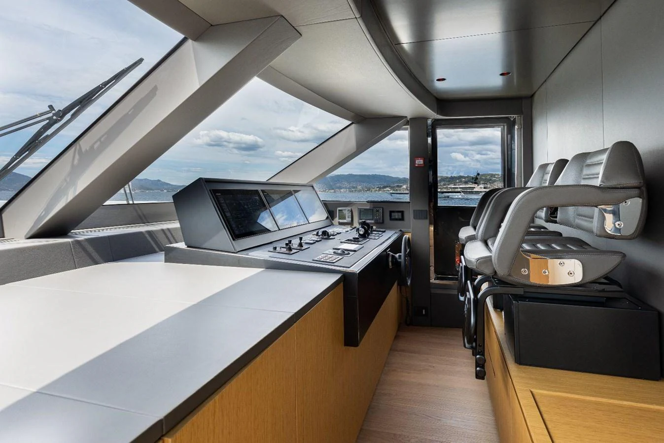 The helm station offers a sleek and modern design with panoramic views. aboard MINI Yacht for Sale