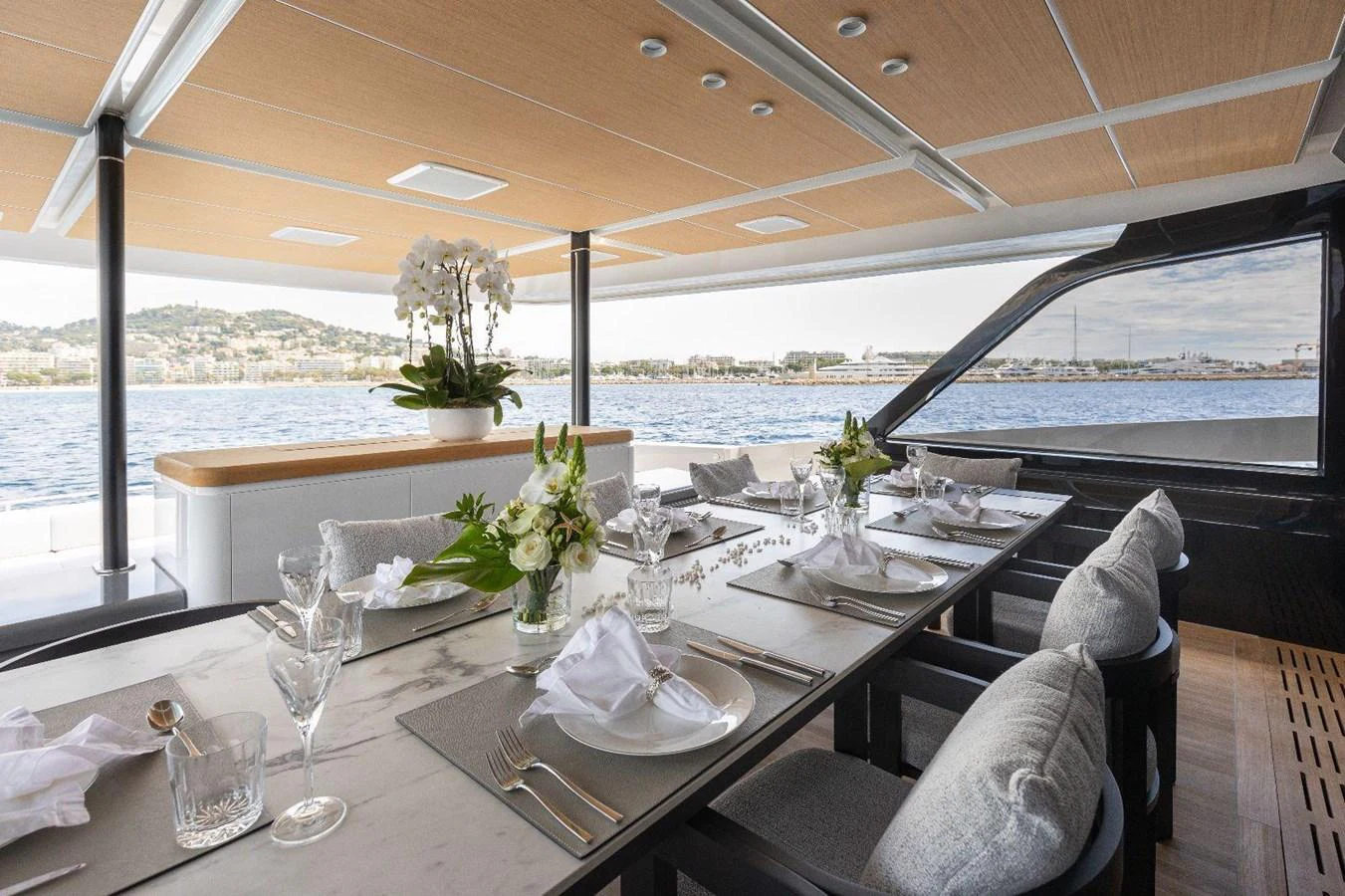 The yacht's dining area offers a luxurious setting with a stunning view of the water. aboard MINI Yacht for Sale