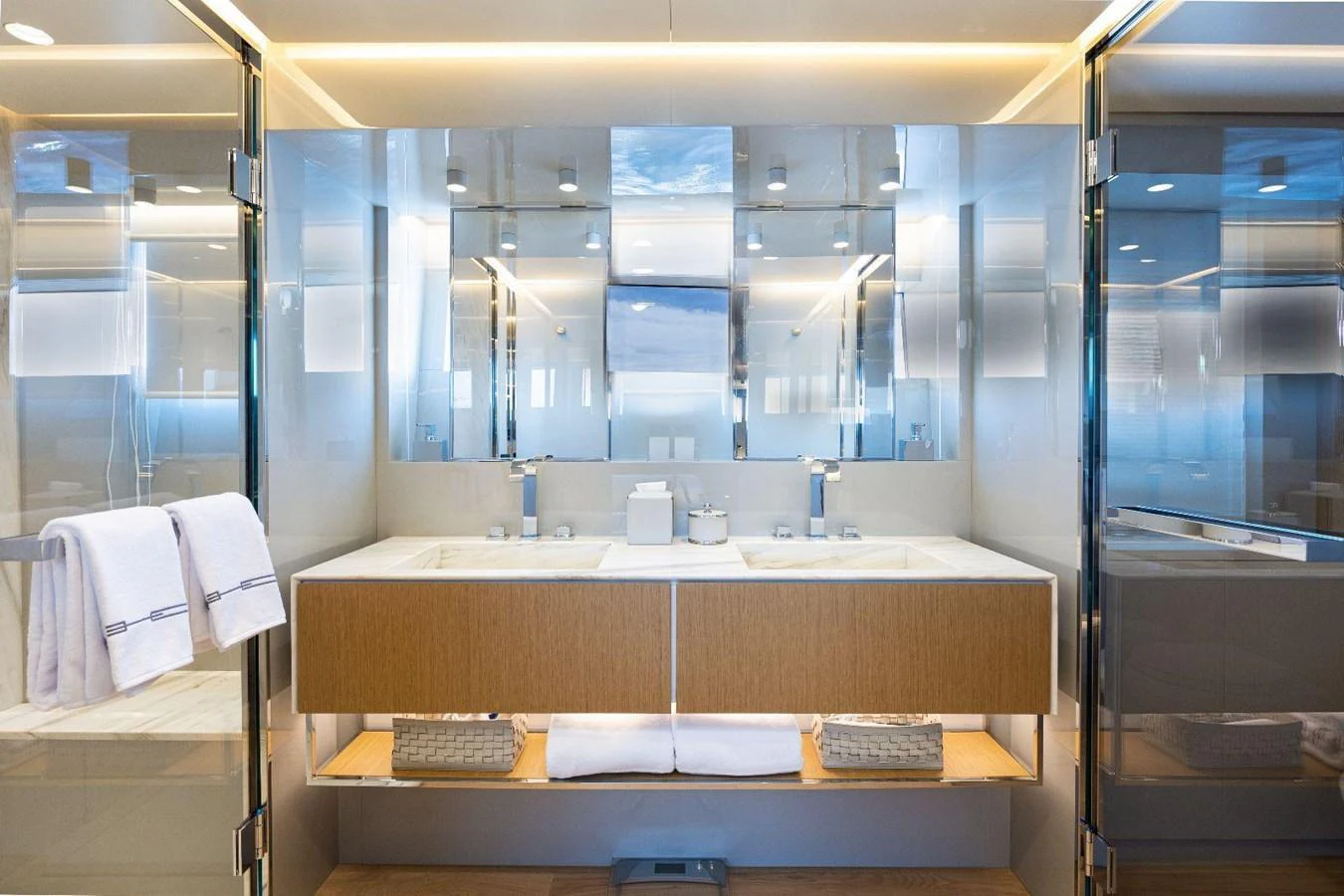 The yacht's bathroom features a sleek, modern design with dual sinks and ample lighting. aboard MINI Yacht for Sale