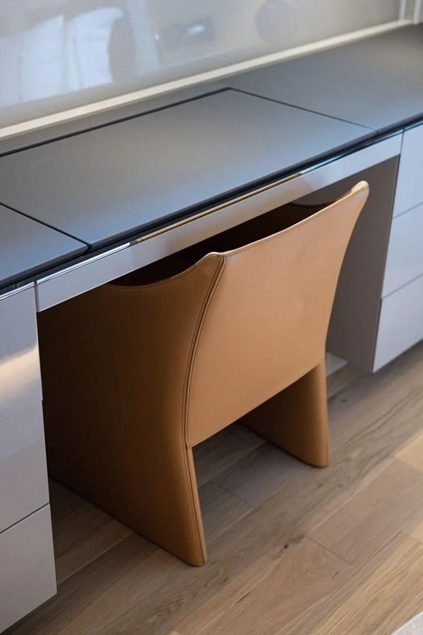A sleek and modern desk area with a stylish leather chair. aboard MINI Yacht for Sale