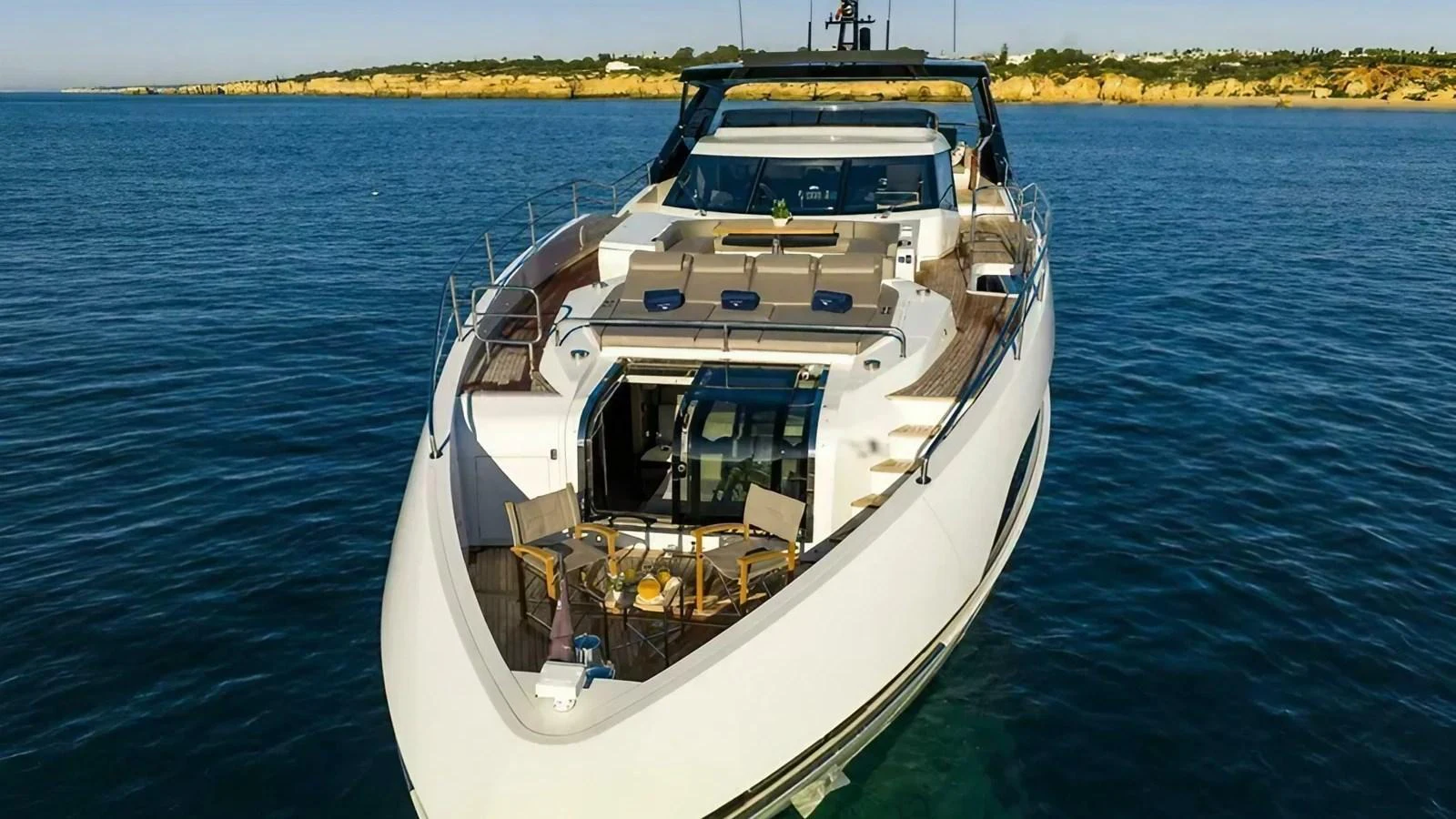 The yacht's foredeck features a spacious seating area with a table, perfect for enjoying the view. aboard CONTESSA Yacht for Sale