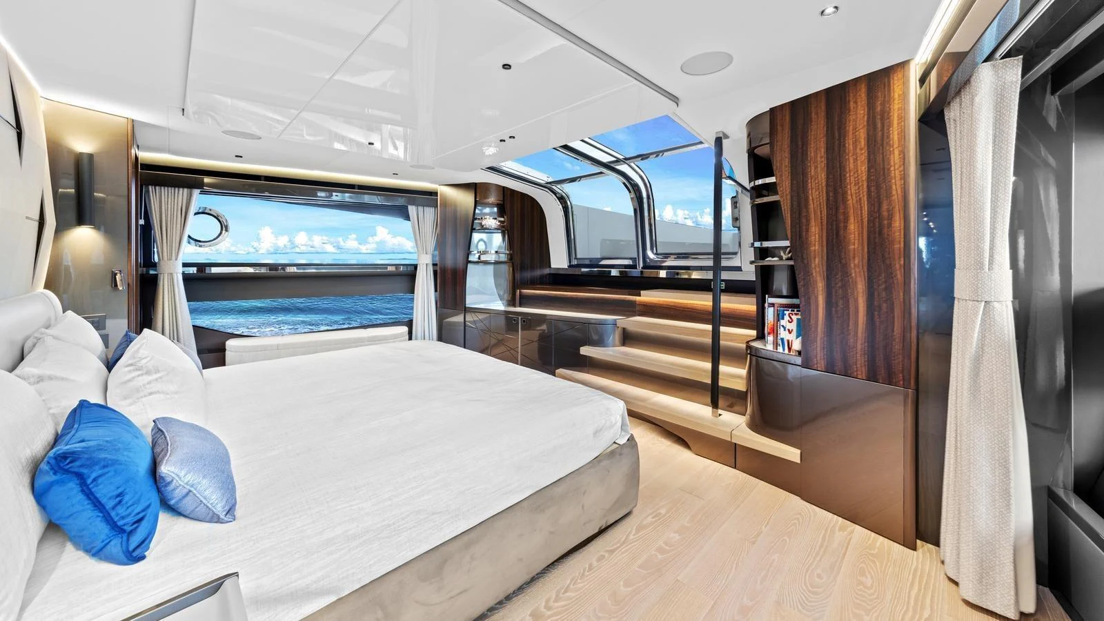 The master stateroom features a luxurious bed, expansive windows, and modern decor with a serene ocean view. aboard CONTESSA Yacht for Sale