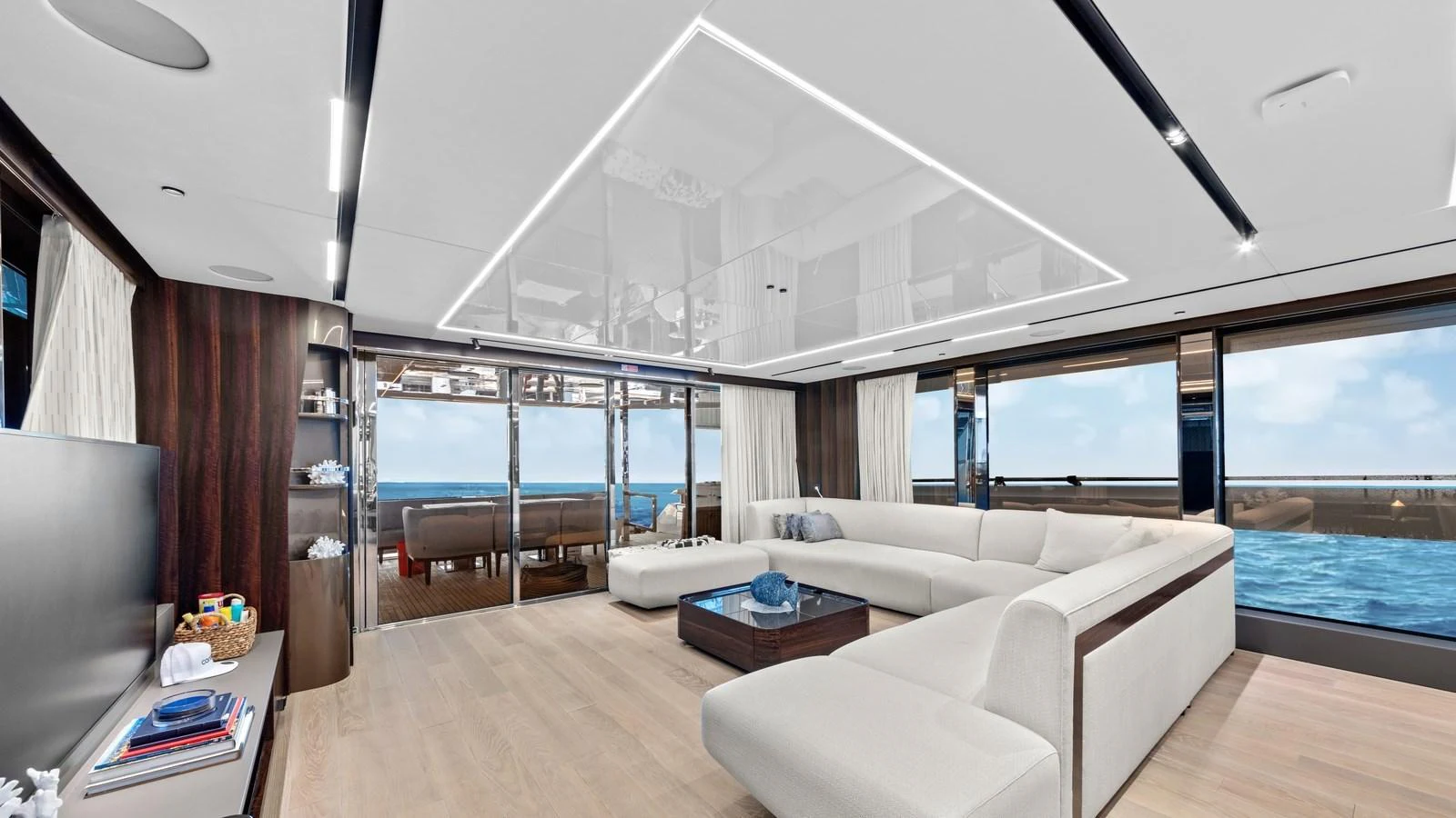 The spacious salon features modern furnishings and large windows offering stunning ocean views. aboard CONTESSA Yacht for Sale