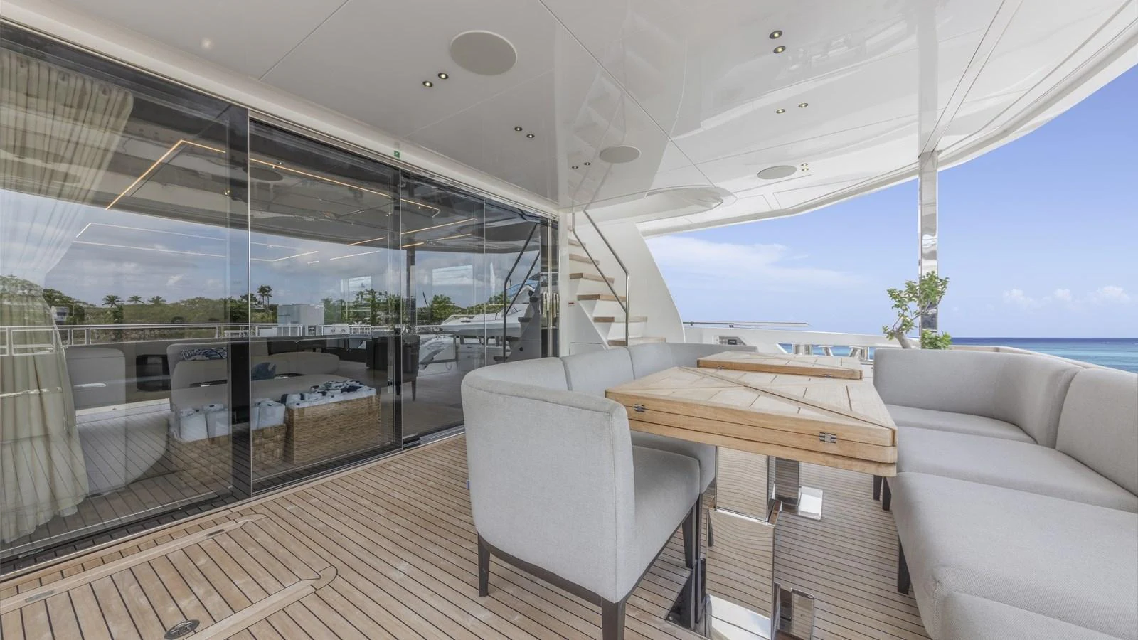 The aft deck features a comfortable seating area with a wooden table, perfect for outdoor dining and relaxation. aboard CONTESSA Yacht for Sale