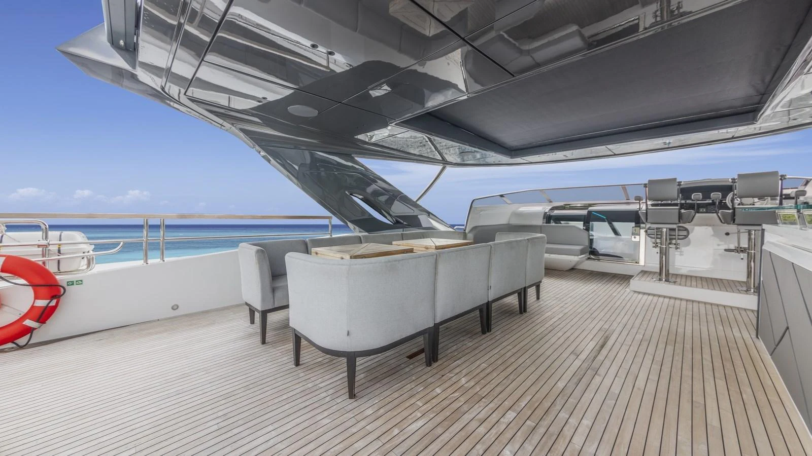 The flybridge offers a spacious and stylish area for relaxation and entertainment with modern seating and a sleek design. aboard CONTESSA Yacht for Sale
