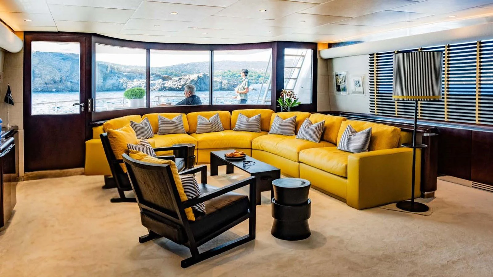 a living room with a yellow couch aboard BELLINI Yacht for Sale