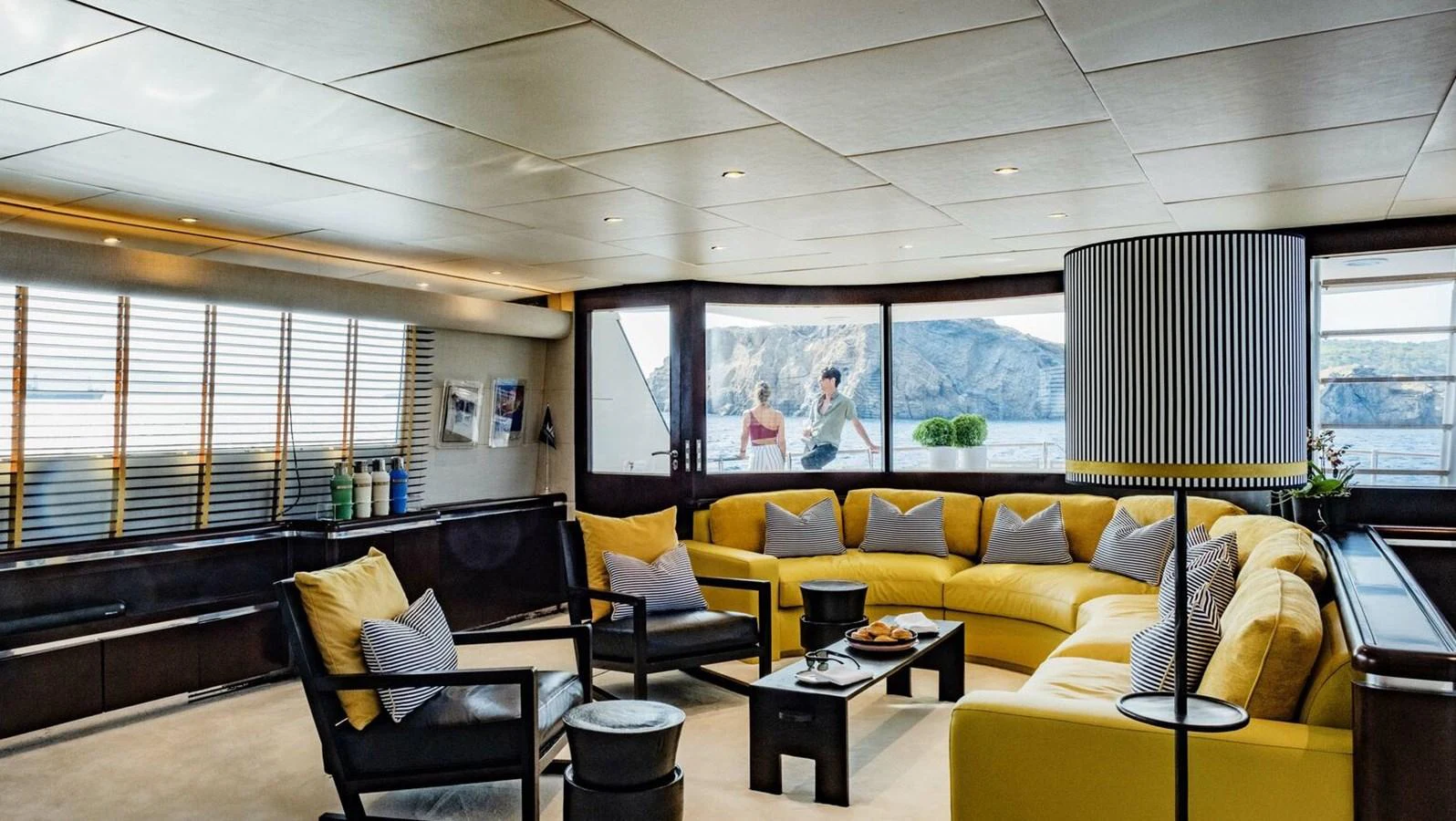 a room with yellow couches and a coffee table aboard BELLINI Yacht for Sale