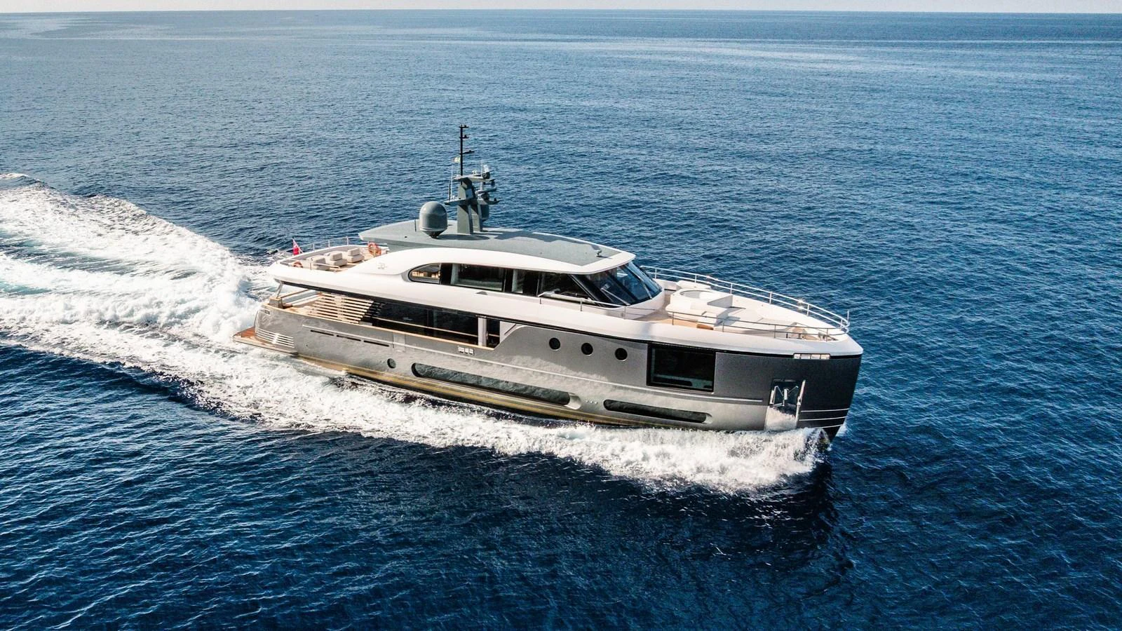 A sleek and modern yacht glides effortlessly across the open sea. aboard ARIA Yacht for Sale