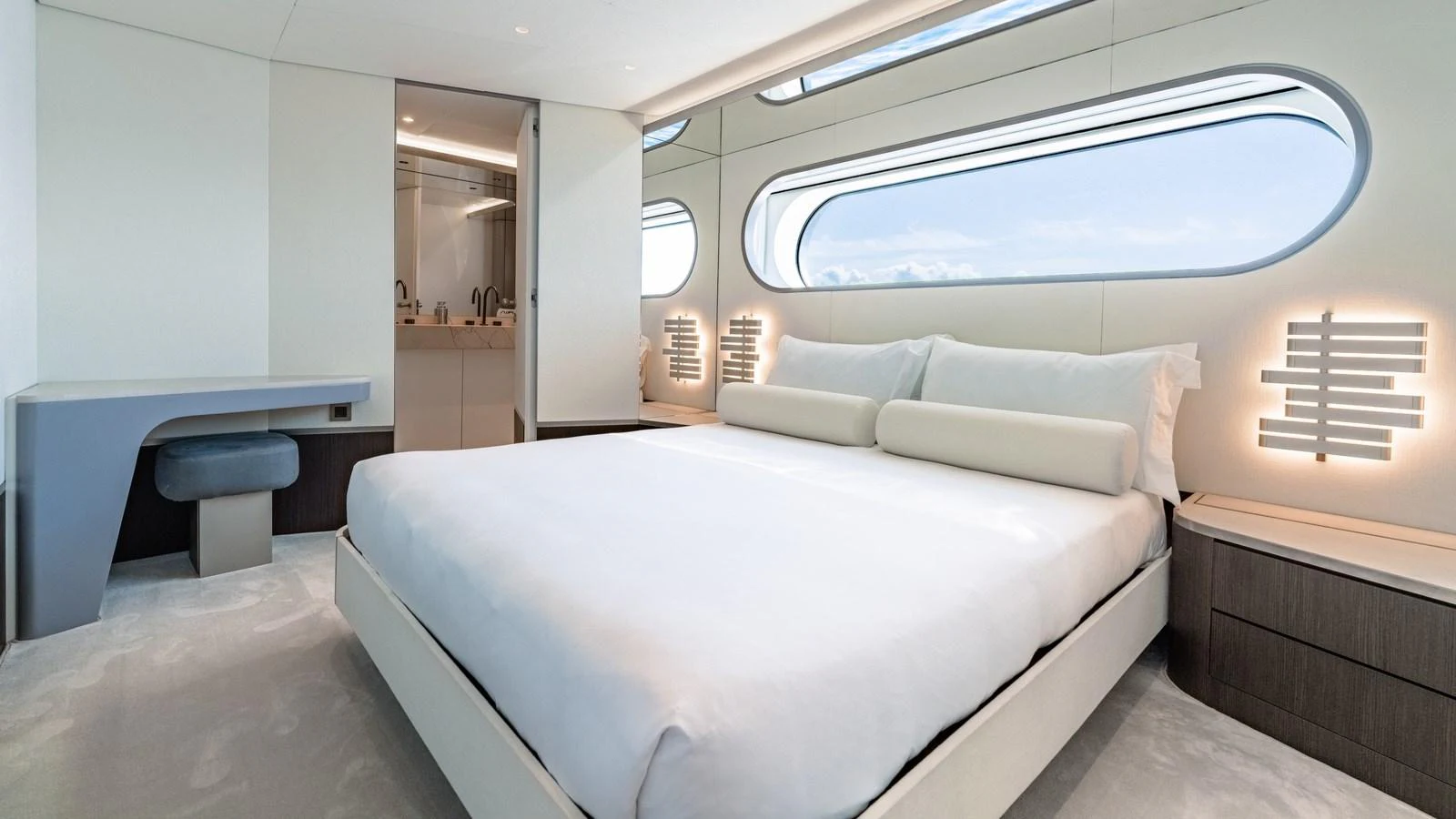 The master stateroom features a spacious bed with modern decor and large windows offering a serene view. aboard ARIA Yacht for Sale