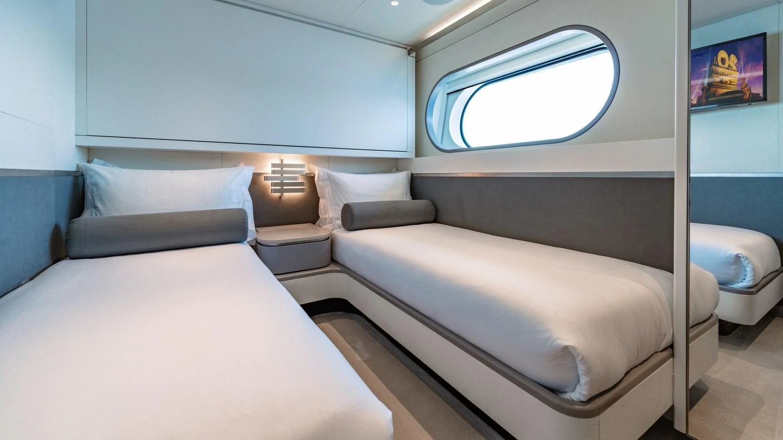 The guest cabin features twin beds with modern decor and a large window for natural light. aboard ARIA Yacht for Sale