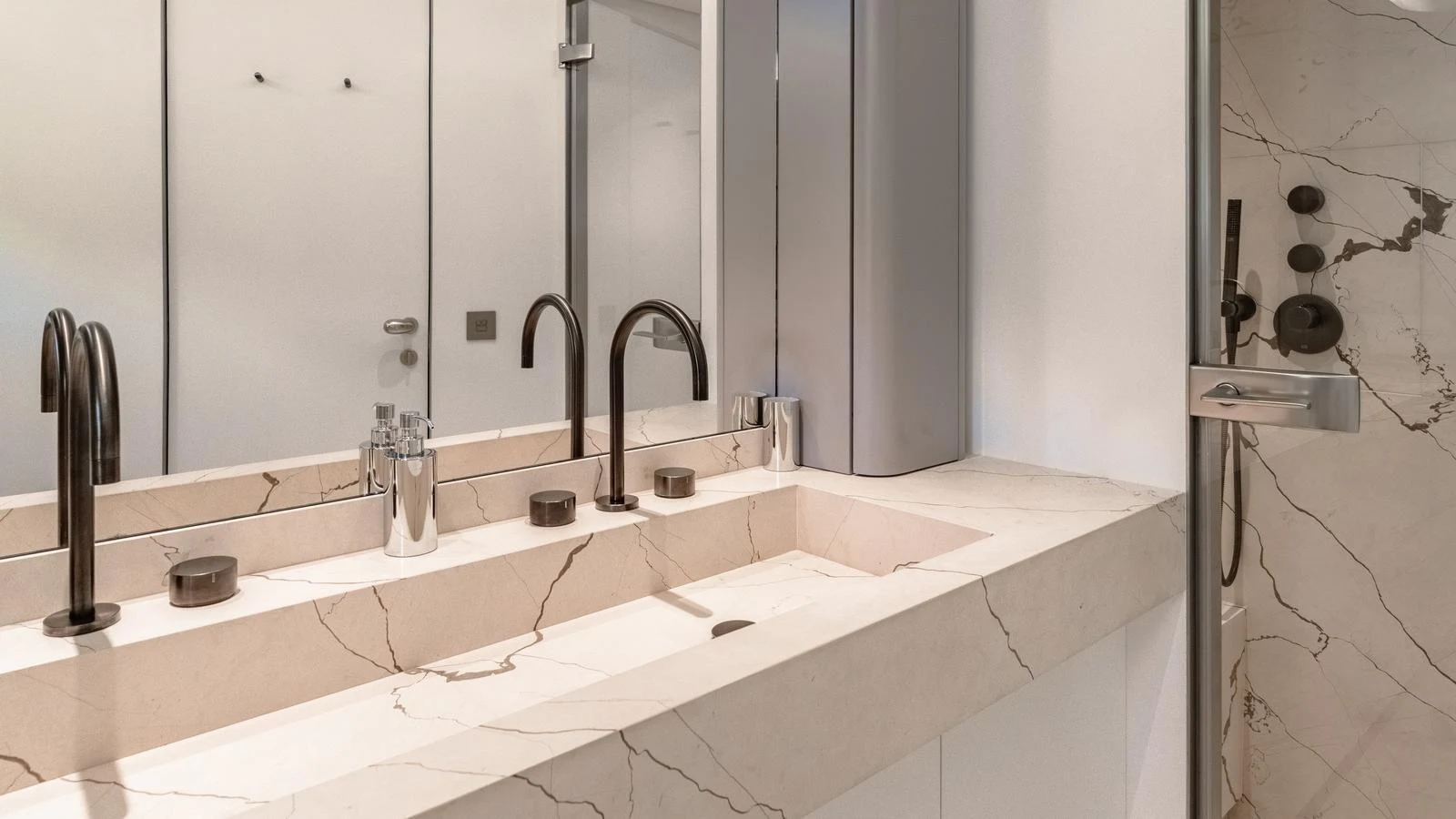 The yacht's bathroom features a luxurious marble countertop with dual sinks and modern fixtures. aboard ARIA Yacht for Sale