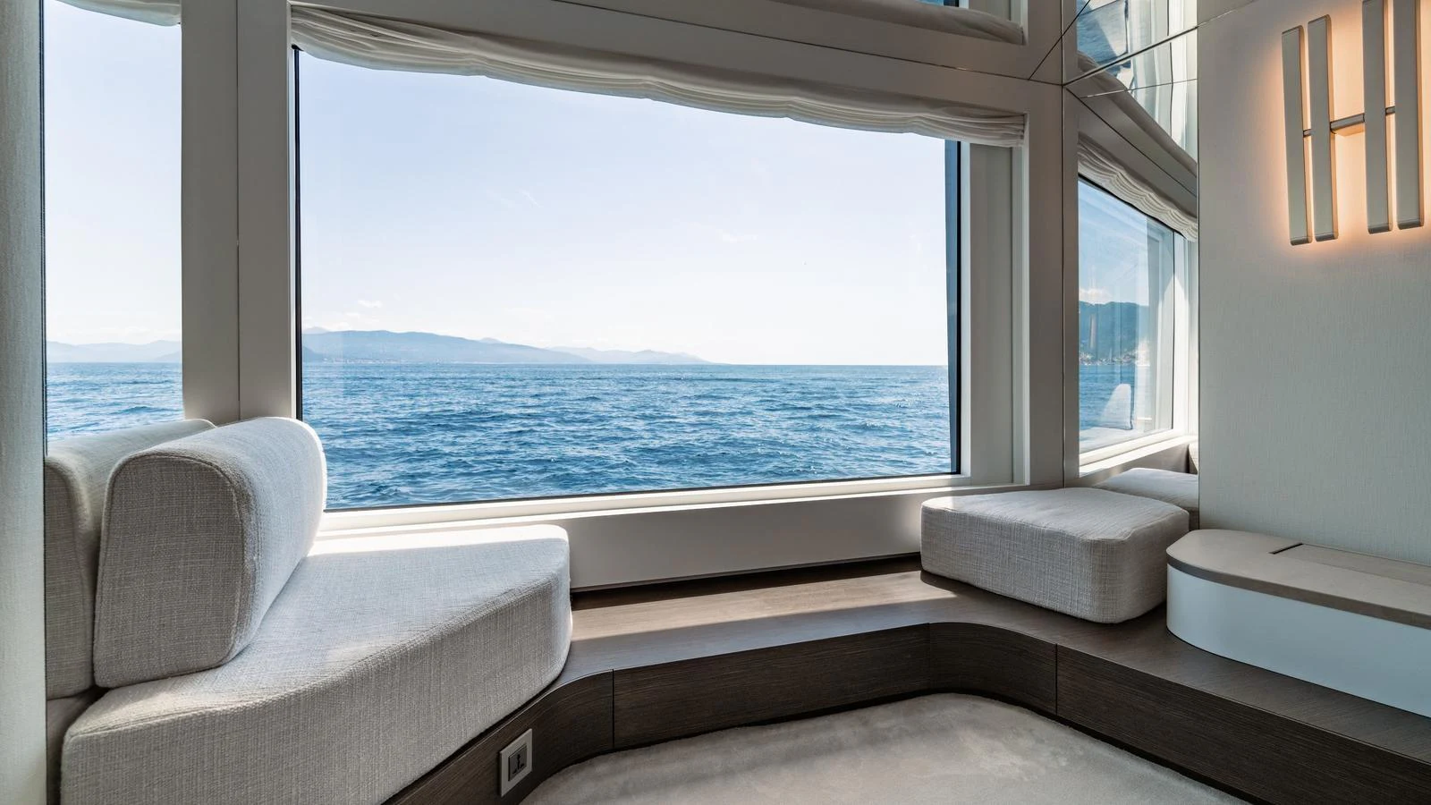 This serene interior space offers a panoramic ocean view through large windows, creating a tranquil atmosphere. aboard ARIA Yacht for Sale