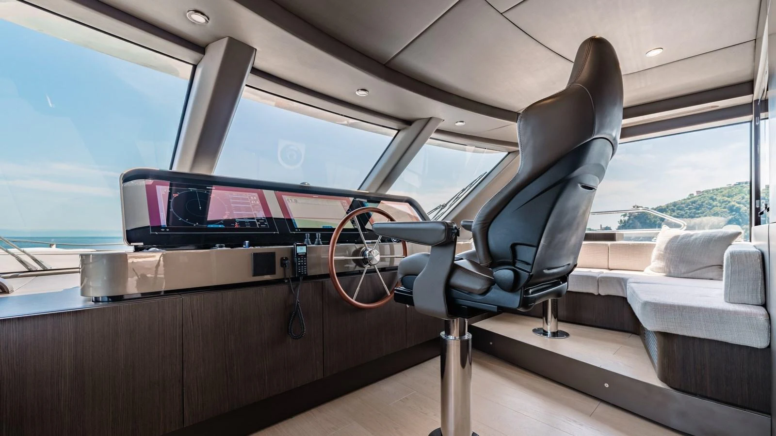 The helm station features a sleek, modern design with panoramic windows offering stunning views. aboard ARIA Yacht for Sale