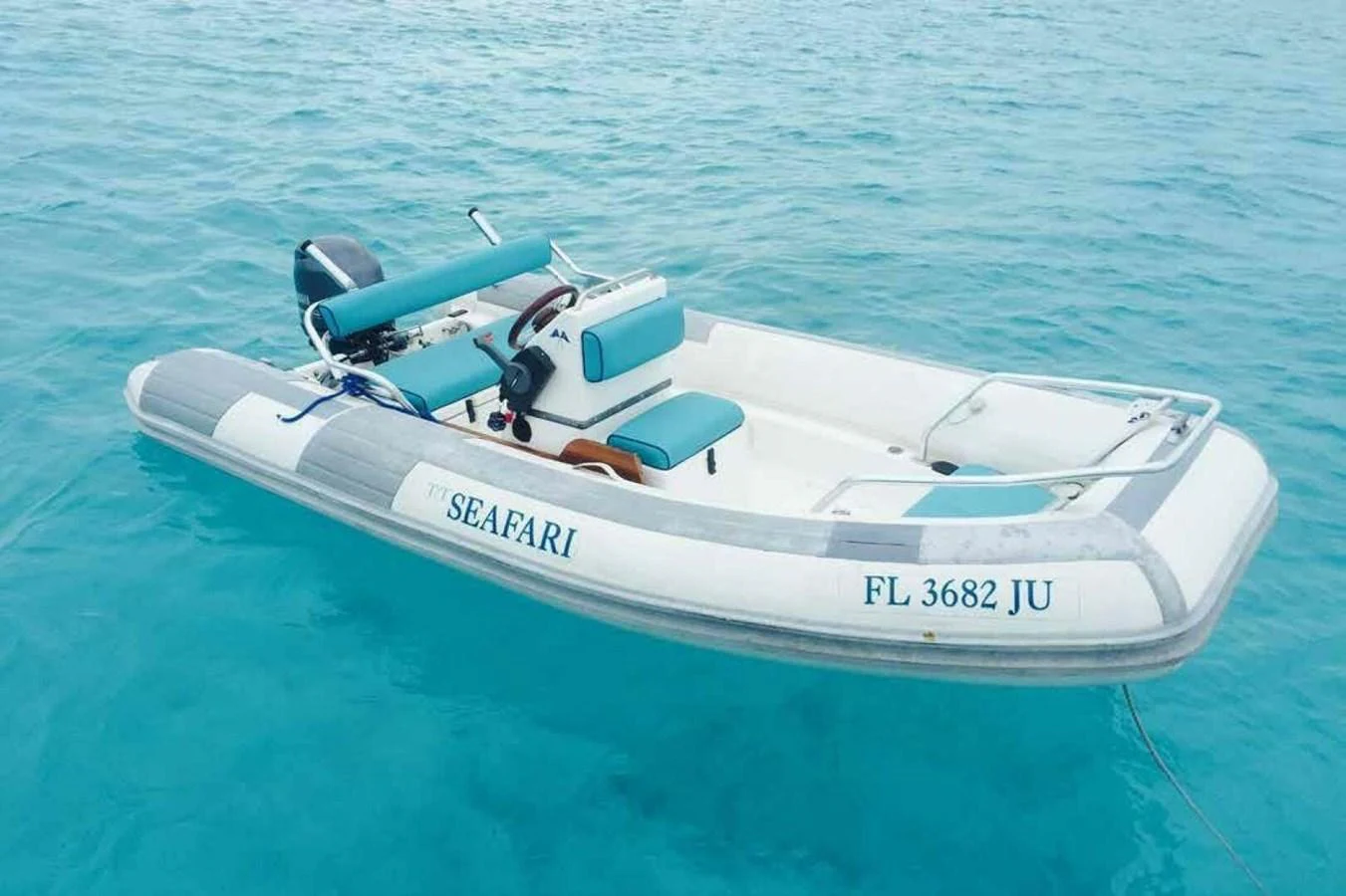 A sleek tender boat floats on clear turquoise waters, ready for adventure. aboard SEAFARI Yacht for Sale