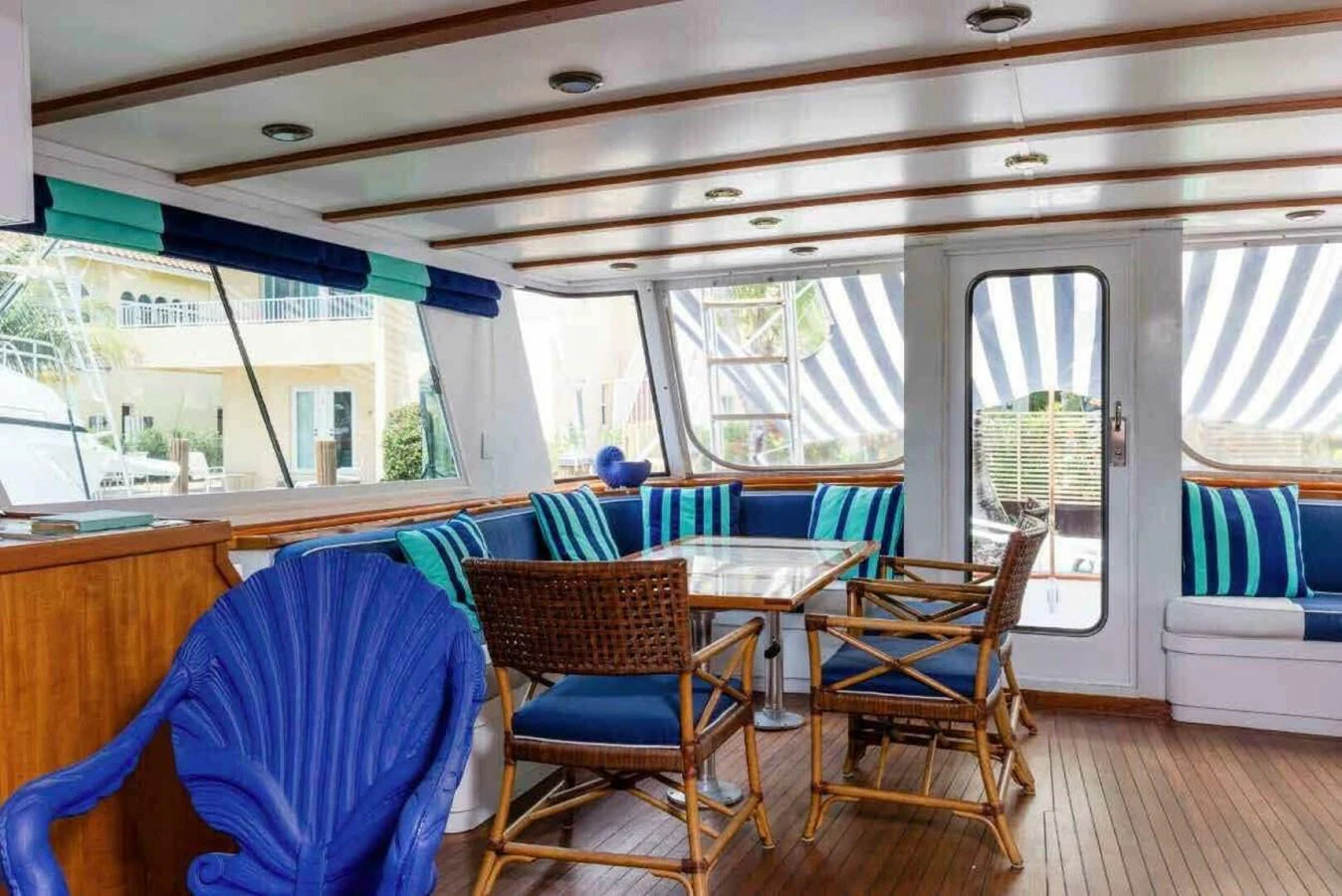 The salon features comfortable seating with a nautical theme and ample natural light. aboard SEAFARI Yacht for Sale