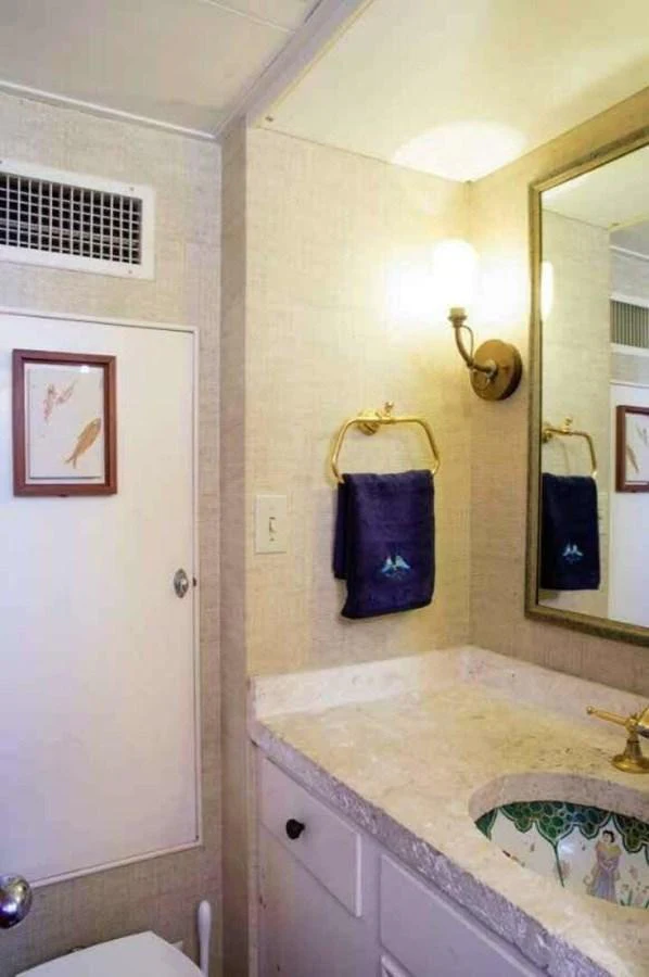 The yacht's bathroom features elegant fixtures and a well-lit vanity area. aboard SEAFARI Yacht for Sale