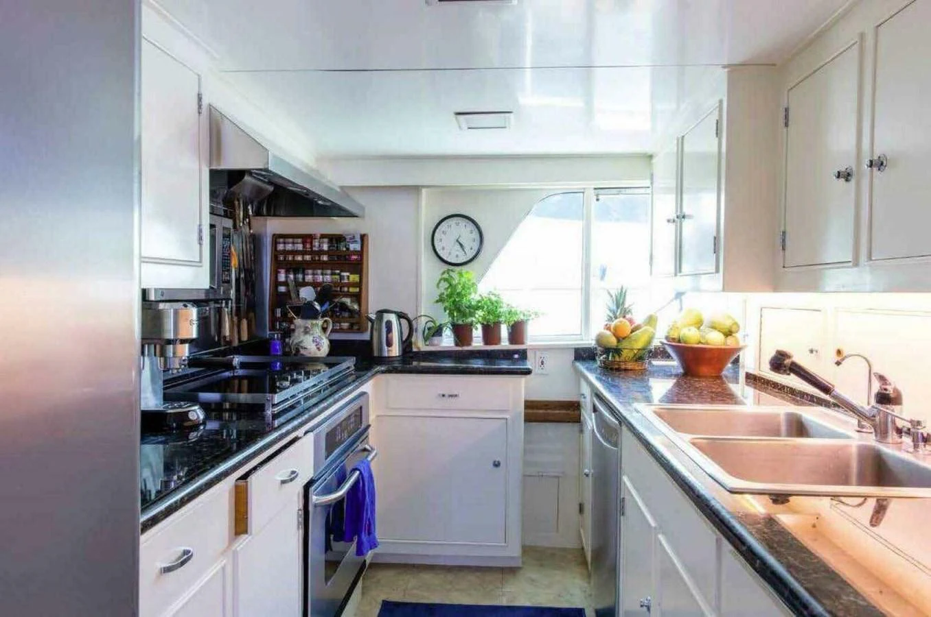 The yacht's galley is equipped with modern appliances and ample counter space, creating a bright and functional cooking area. aboard SEAFARI Yacht for Sale