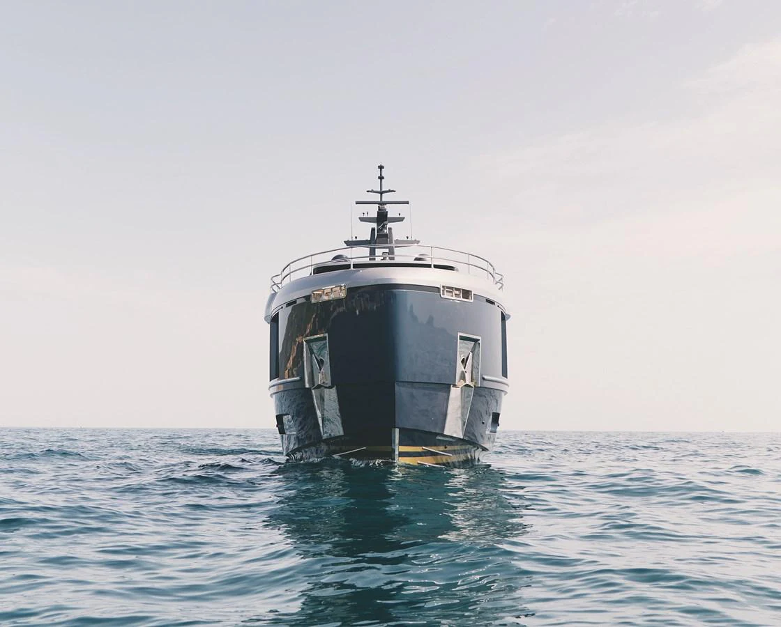 A sleek yacht is captured head-on, showcasing its modern design and presence on the water. aboard PALMAX Yacht for Sale