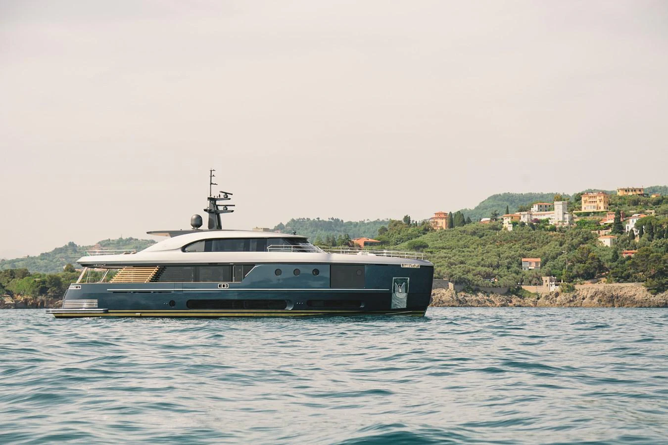 A sleek and modern yacht cruises along a picturesque coastline, showcasing its elegant design and luxurious features. aboard PALMAX Yacht for Sale