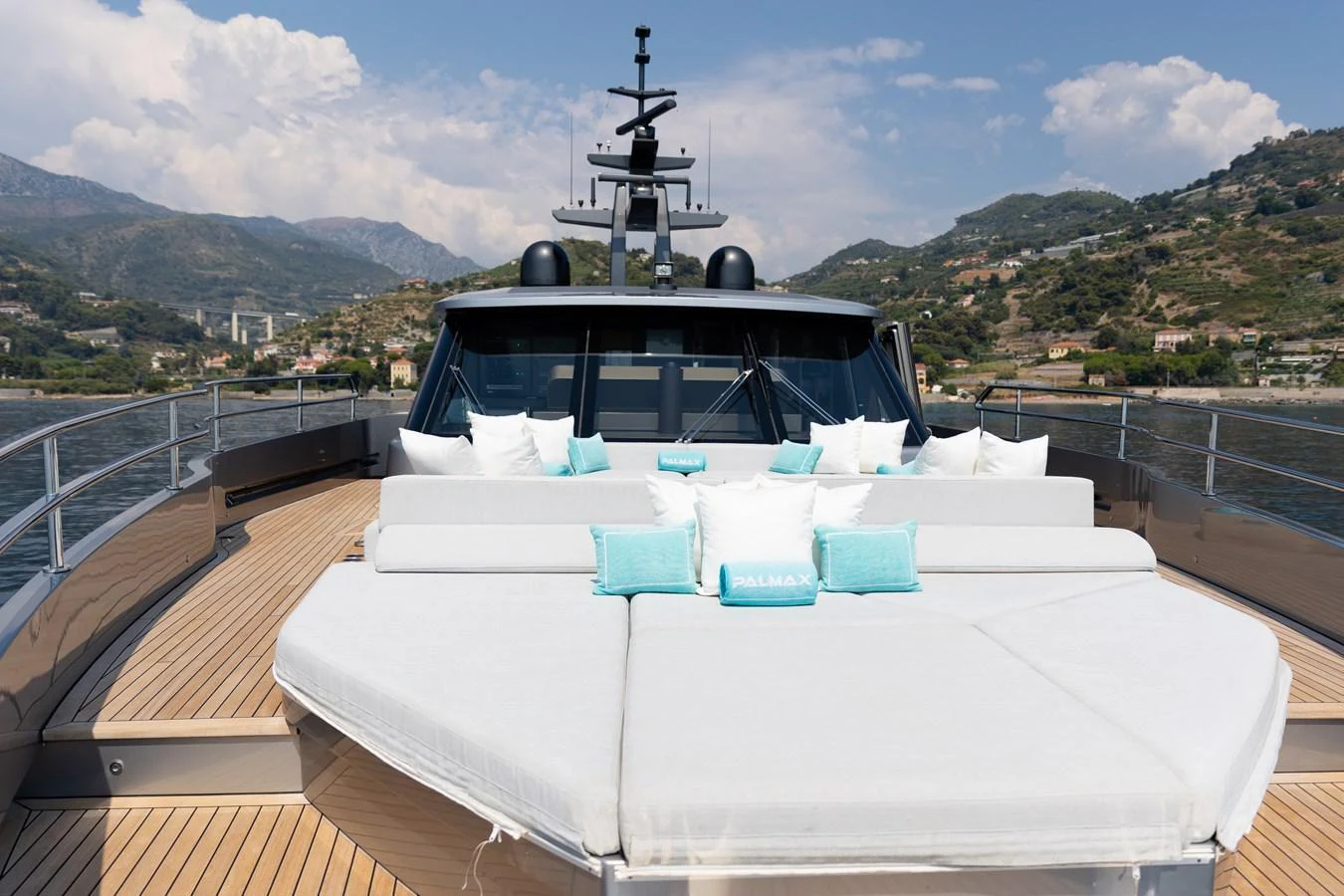 The yacht's foredeck features luxurious sun pads with scenic views of the surrounding landscape. aboard PALMAX Yacht for Sale
