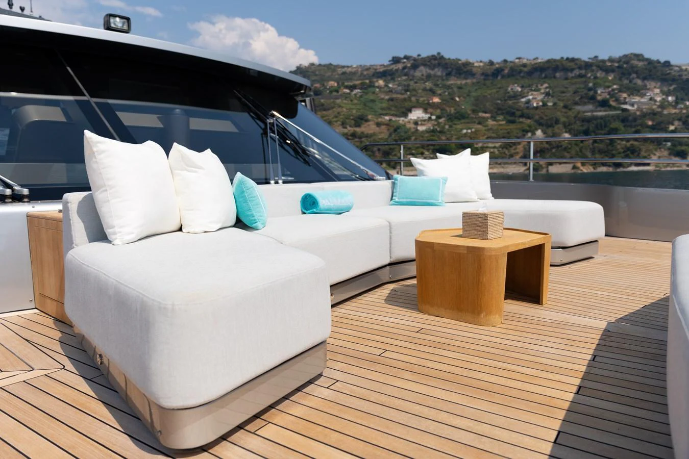 The sundeck features luxurious seating with plush cushions and a stylish wooden table, perfect for relaxation. aboard PALMAX Yacht for Sale