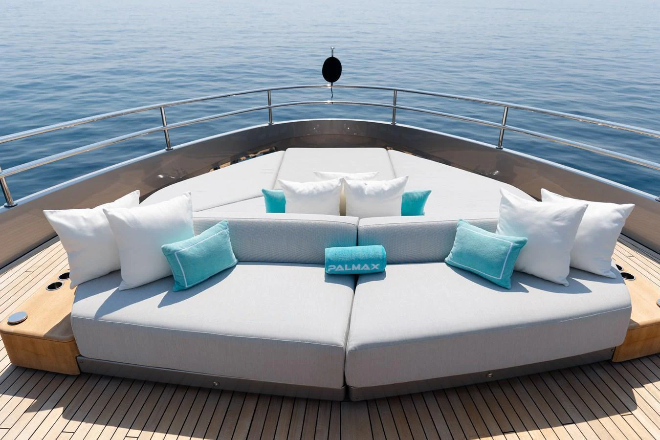 The foredeck features a luxurious sunbathing area with plush cushions and scenic ocean views. aboard PALMAX Yacht for Sale