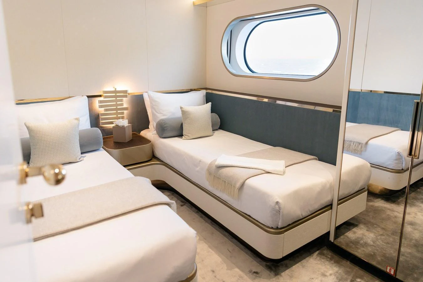 The guest stateroom features twin beds with a modern, elegant design and a large window for natural light. aboard PALMAX Yacht for Sale