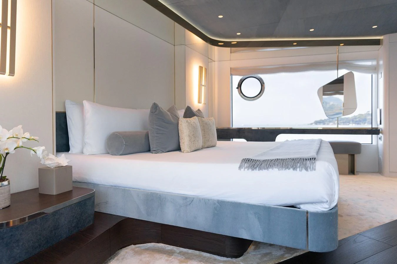 The stateroom features a luxurious bed with elegant decor and a stunning view through the large window. aboard PALMAX Yacht for Sale
