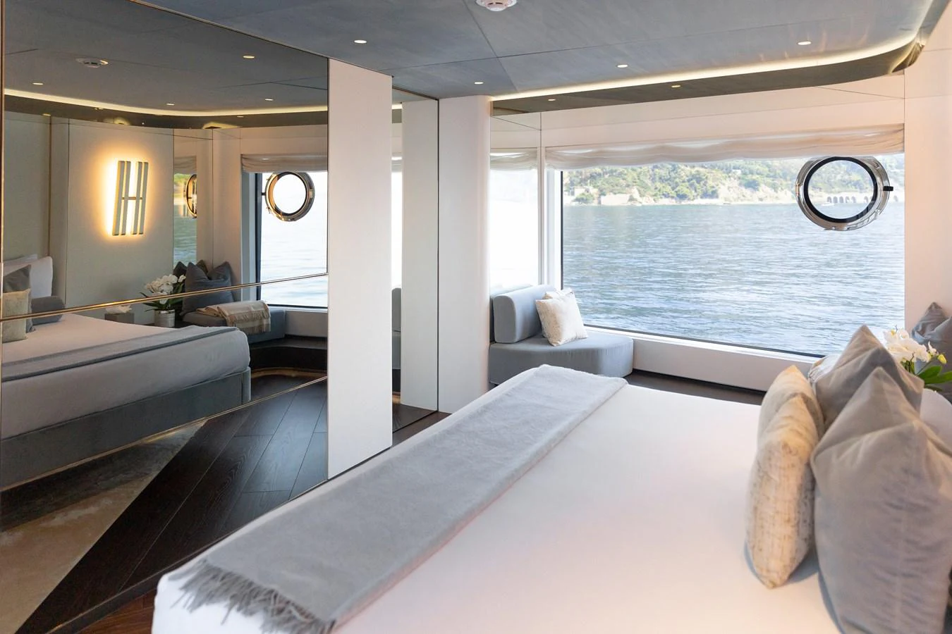 A luxurious stateroom with panoramic windows offering stunning water views. aboard PALMAX Yacht for Sale