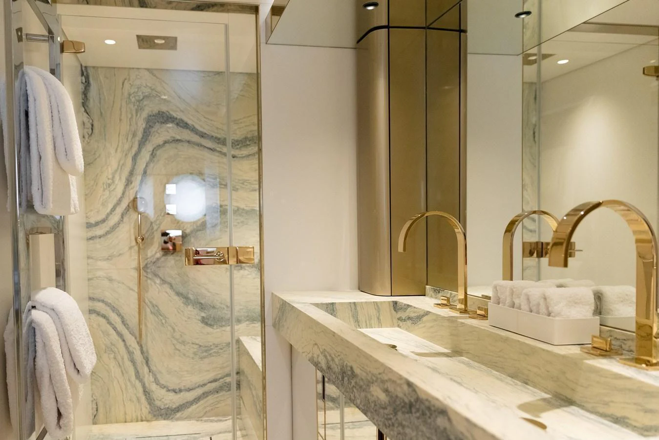 The yacht's bathroom features luxurious marble surfaces and elegant gold fixtures. aboard PALMAX Yacht for Sale