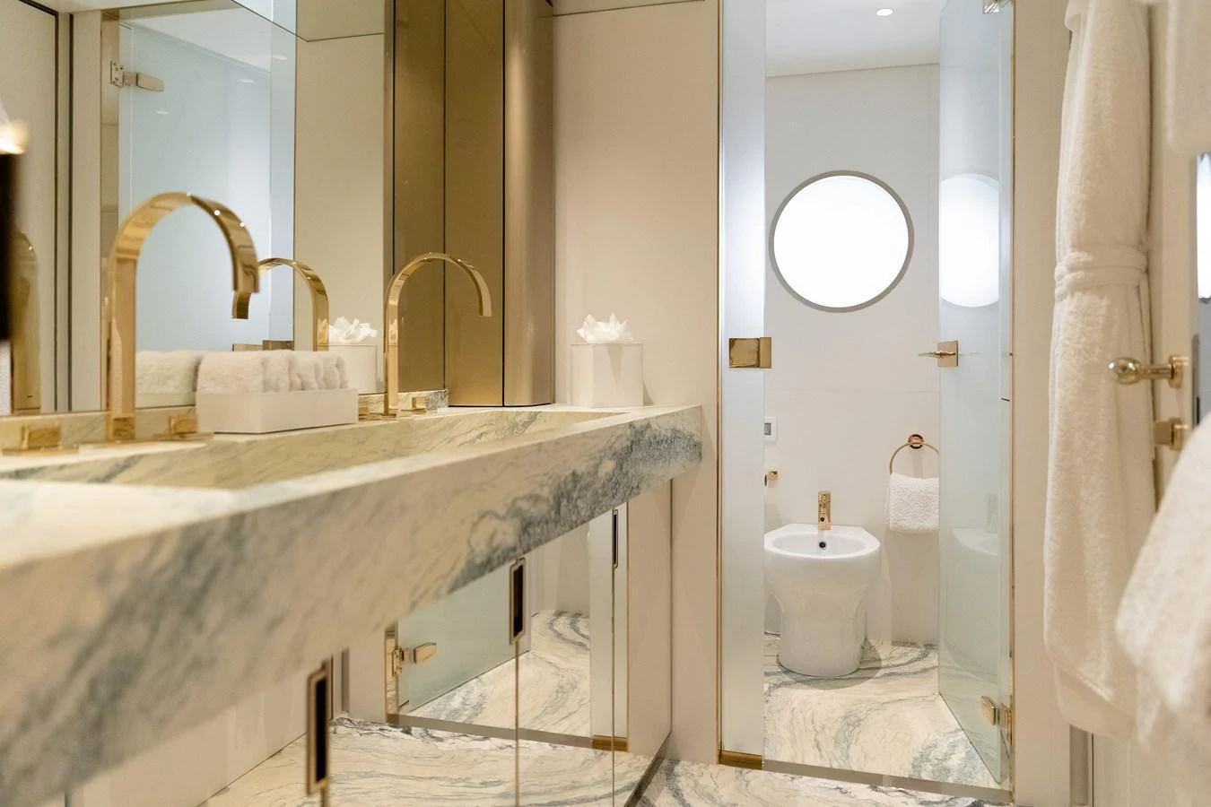 The yacht's bathroom features luxurious marble finishes and elegant gold fixtures. aboard PALMAX Yacht for Sale