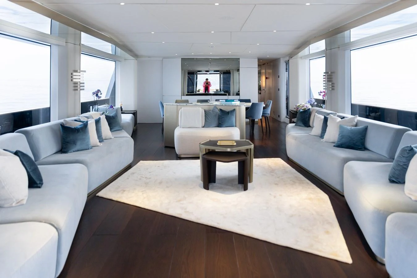 The salon features elegant seating with a modern design and ample natural light. aboard PALMAX Yacht for Sale