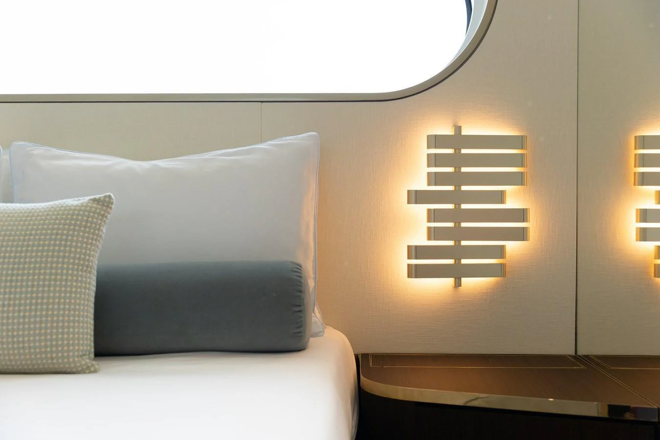 A serene stateroom featuring elegant lighting and plush bedding. aboard PALMAX Yacht for Sale