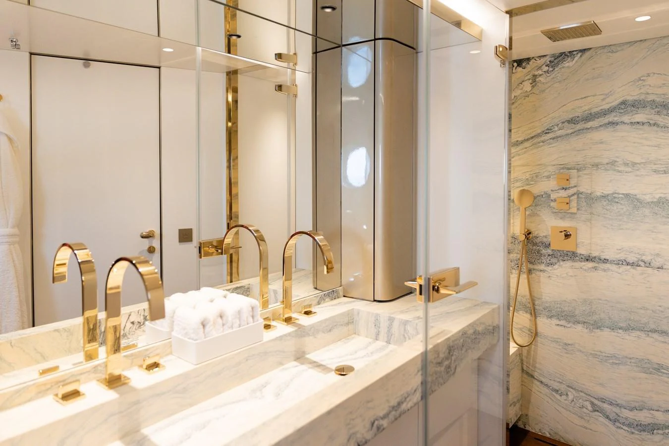 The yacht's bathroom features luxurious marble finishes and gold fixtures, creating an elegant and serene atmosphere. aboard PALMAX Yacht for Sale