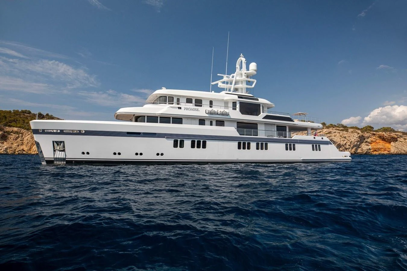 A luxurious yacht glides gracefully on the open sea, showcasing its elegant design and spacious decks. aboard PROMISE Yacht for Sale
