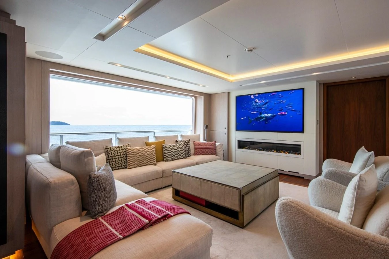 The salon offers a spacious and comfortable seating area with a large window providing stunning ocean views. aboard PROMISE Yacht for Sale