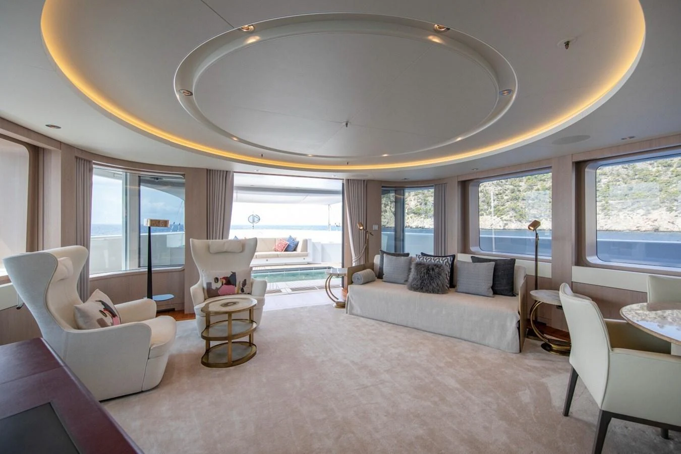 The spacious salon features elegant seating and expansive windows offering stunning views. aboard PROMISE Yacht for Sale