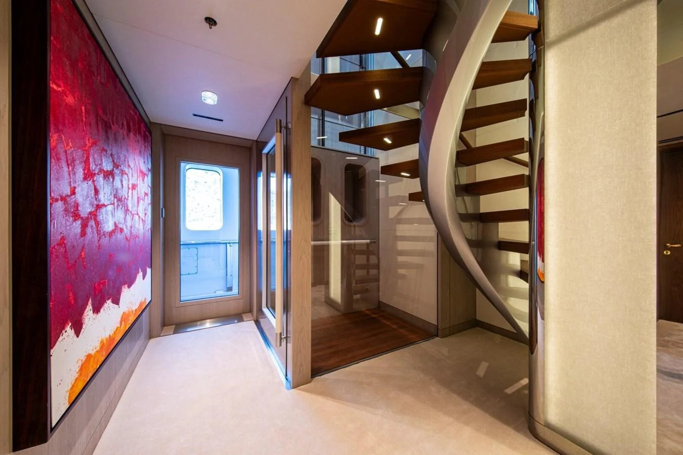 A stylish interior featuring a modern staircase with wooden steps and a vibrant red artwork on the wall. aboard PROMISE Yacht for Sale