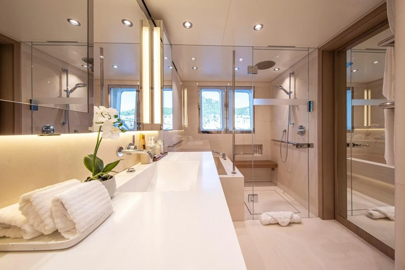 The yacht's bathroom features a sleek, modern design with luxurious amenities and ample natural light. aboard PROMISE Yacht for Sale