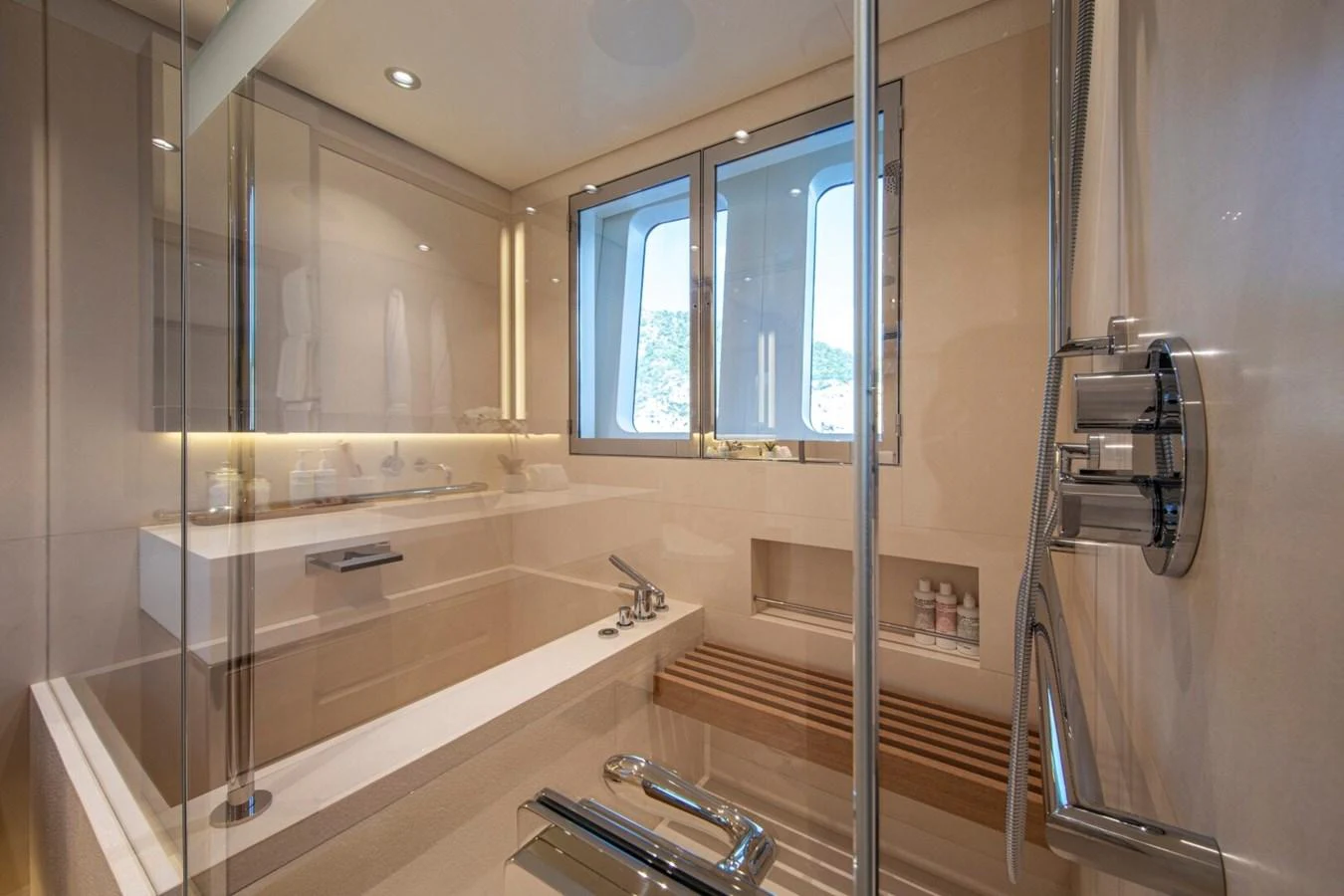 The yacht's bathroom features a sleek design with modern fixtures and a large window for natural light. aboard PROMISE Yacht for Sale