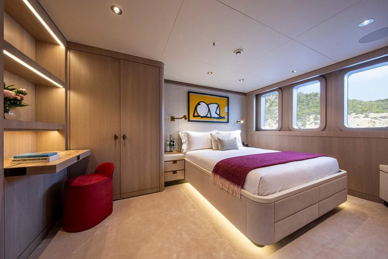 A luxurious stateroom featuring a comfortable bed, modern decor, and ample natural light. aboard PROMISE Yacht for Sale