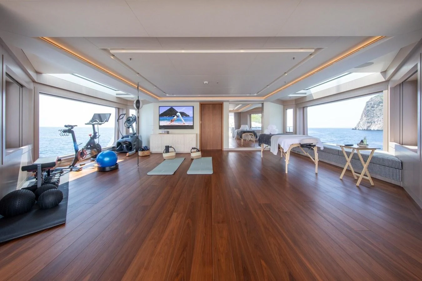 The yacht's gym features modern equipment and stunning ocean views. aboard PROMISE Yacht for Sale