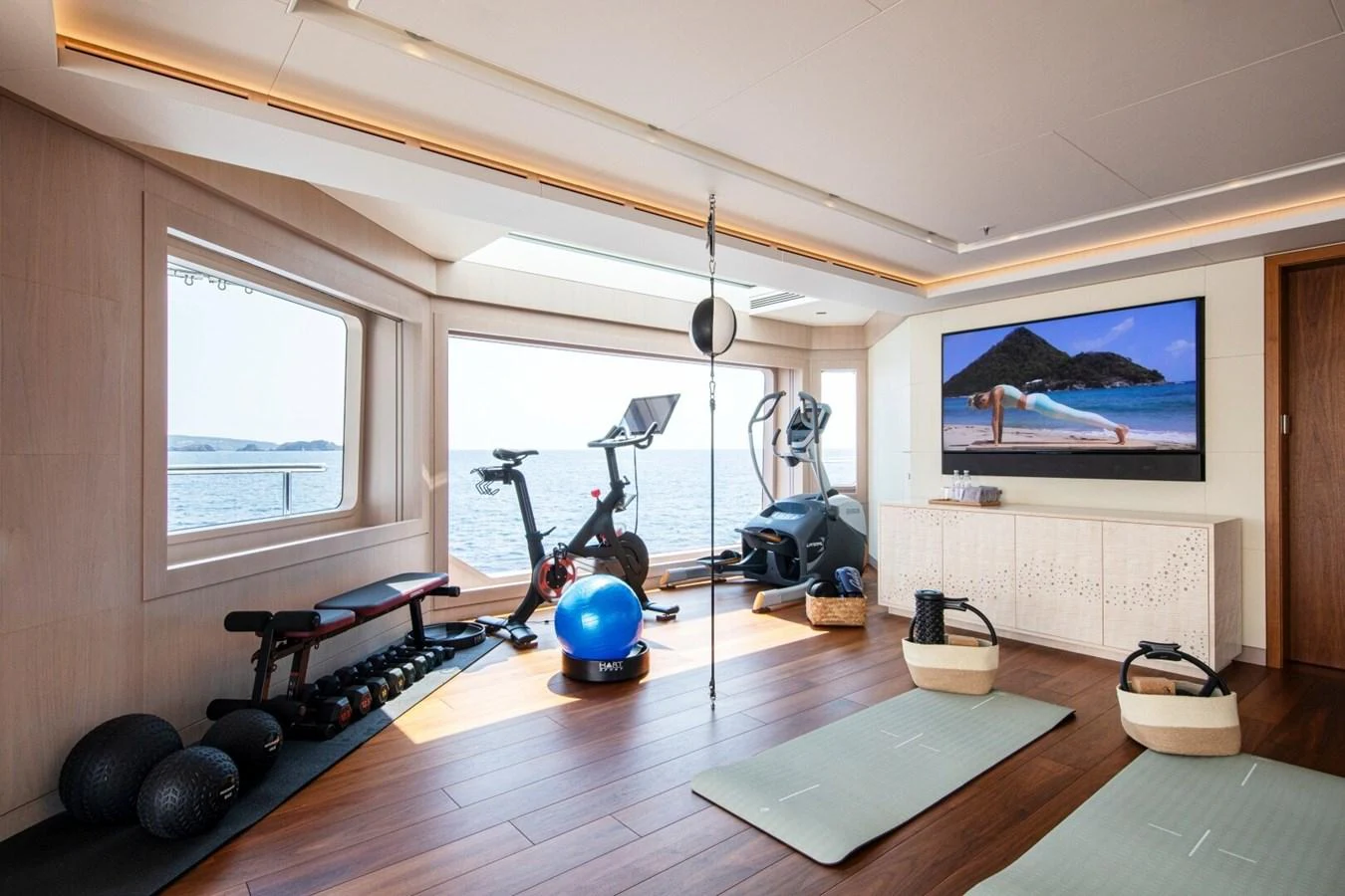 The yacht's gym offers a well-equipped space with stunning sea views for a luxurious workout experience. aboard PROMISE Yacht for Sale