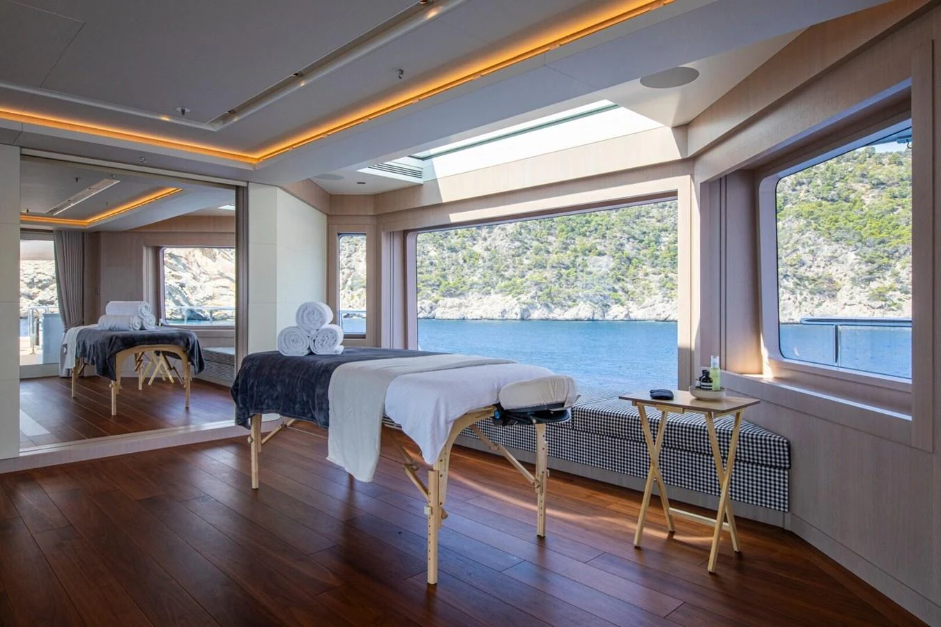 The yacht features a serene spa room with large windows offering stunning views of the surrounding waters. aboard PROMISE Yacht for Sale