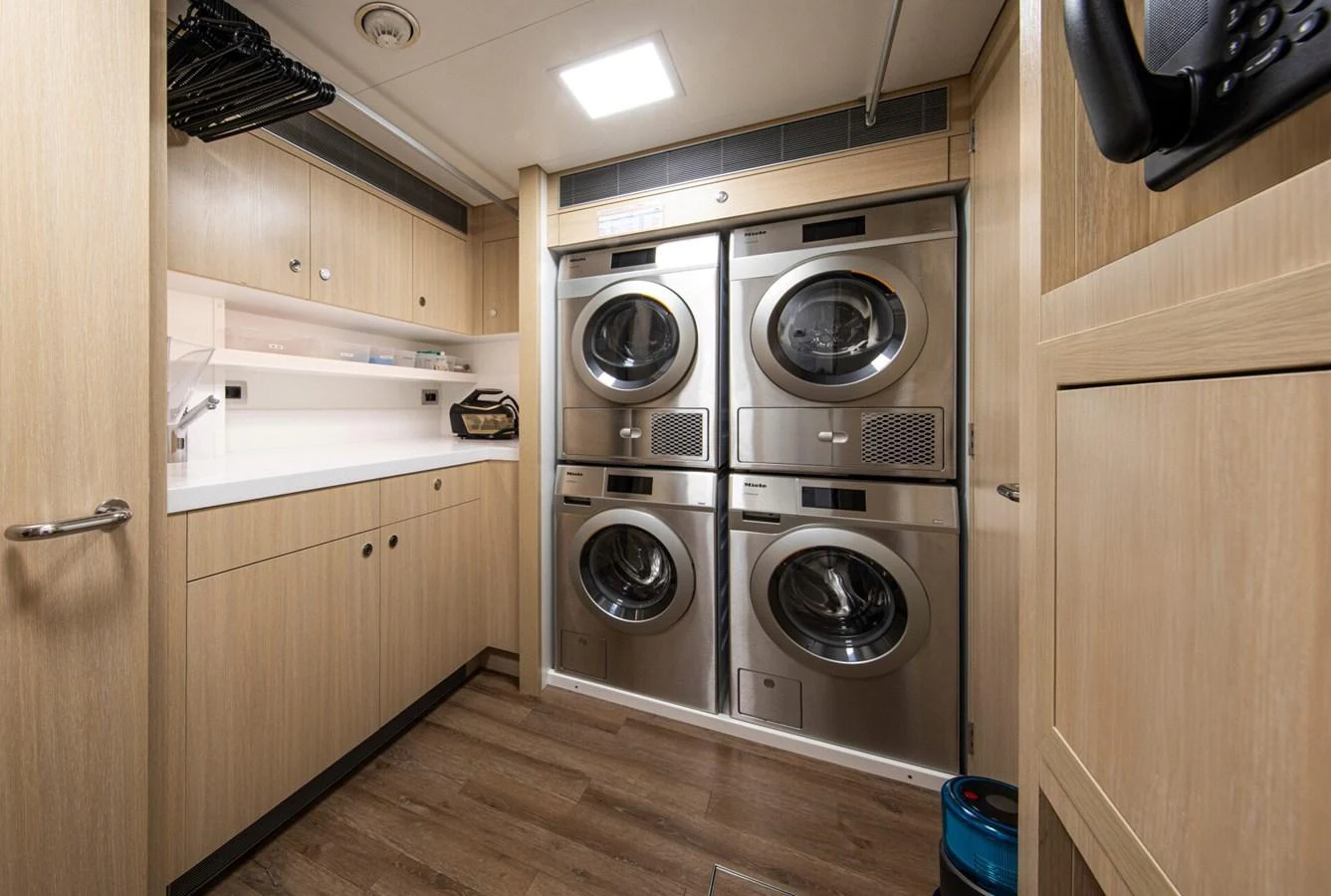 The yacht's laundry room is equipped with modern appliances and ample storage space. aboard PROMISE Yacht for Sale