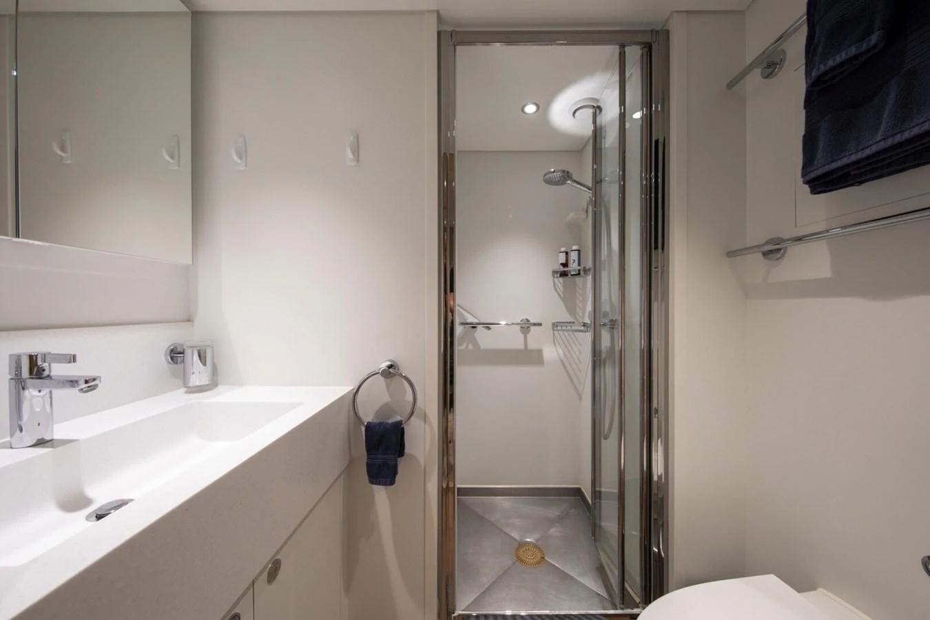 A sleek and modern yacht bathroom with a spacious shower and elegant fixtures. aboard PROMISE Yacht for Sale