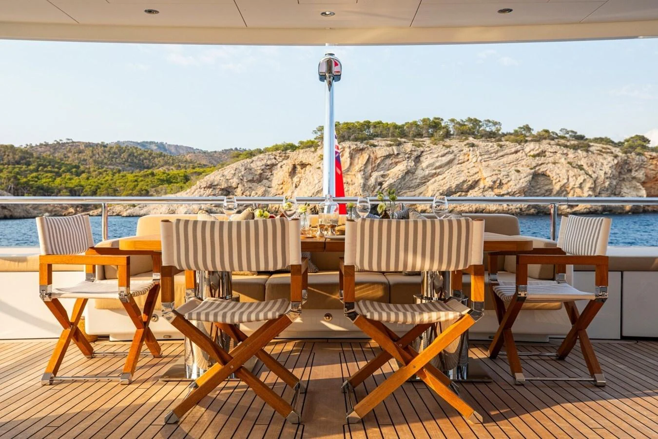 The aft deck features a stylish dining area with comfortable seating and scenic views. aboard PROMISE Yacht for Sale