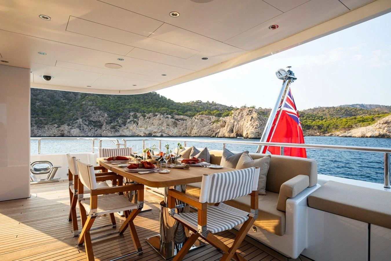 The aft deck features an elegant dining area with comfortable seating and scenic ocean views. aboard PROMISE Yacht for Sale
