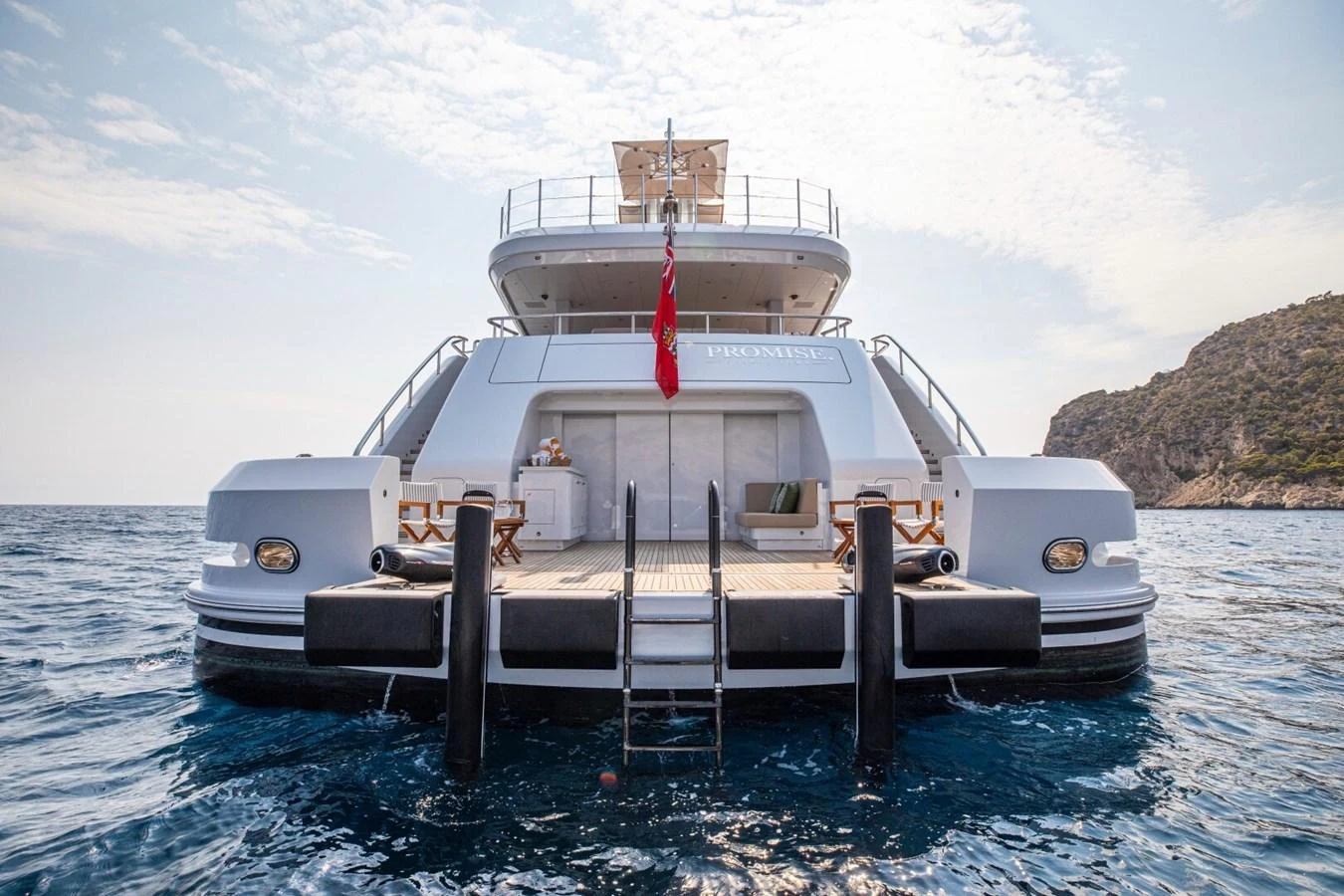 The yacht's aft deck features a spacious lounging area with direct access to the water. aboard PROMISE Yacht for Sale