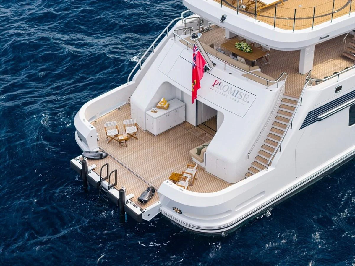 The aft deck of this luxurious yacht features a spacious lounging area with direct access to the water. aboard PROMISE Yacht for Sale